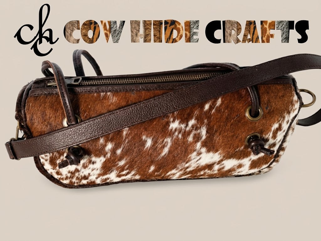 Cowhide bag with leather straps threaded through brass grommets