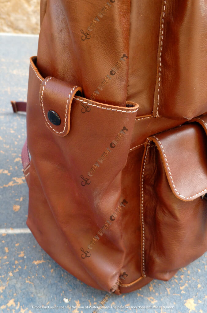 Brown leather backpack side bottle holder pocket