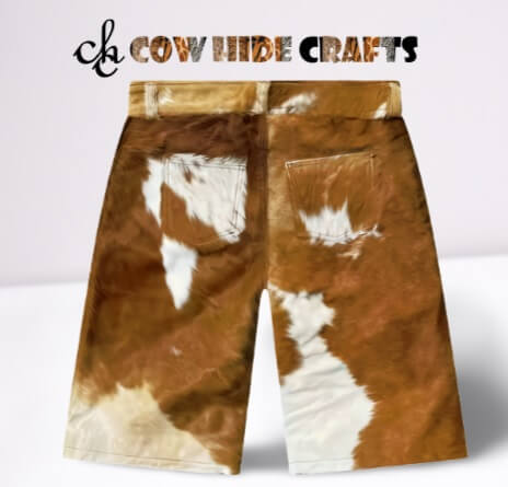 Button closure detail on brown and white cowhide shorts