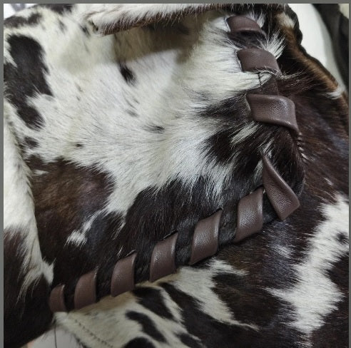 Braided leather whipstitch trim detail on duster coat shoulder