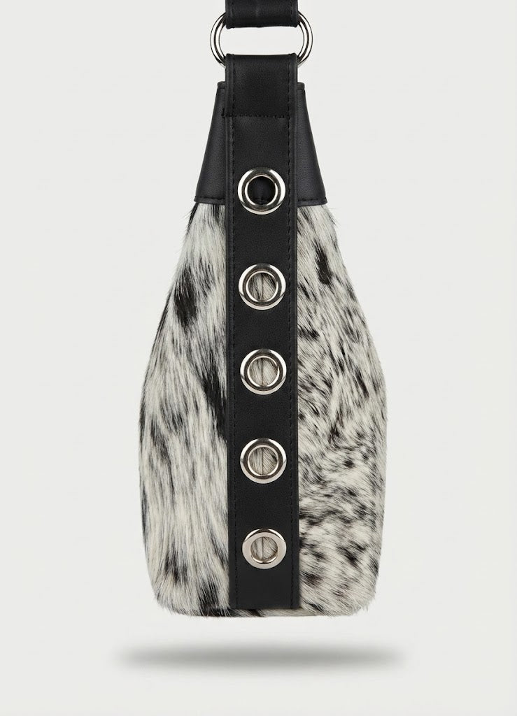 Silver grommet side panel detail on cowhide hobo bag