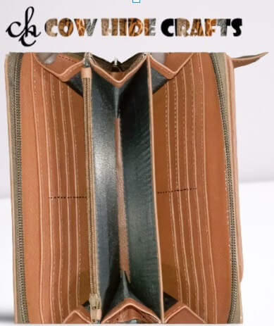 Hidden zipper pocket travel leather hair on tan and white organizer.