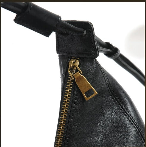 Leather tassel drawstring detail on dumpling crescent bag