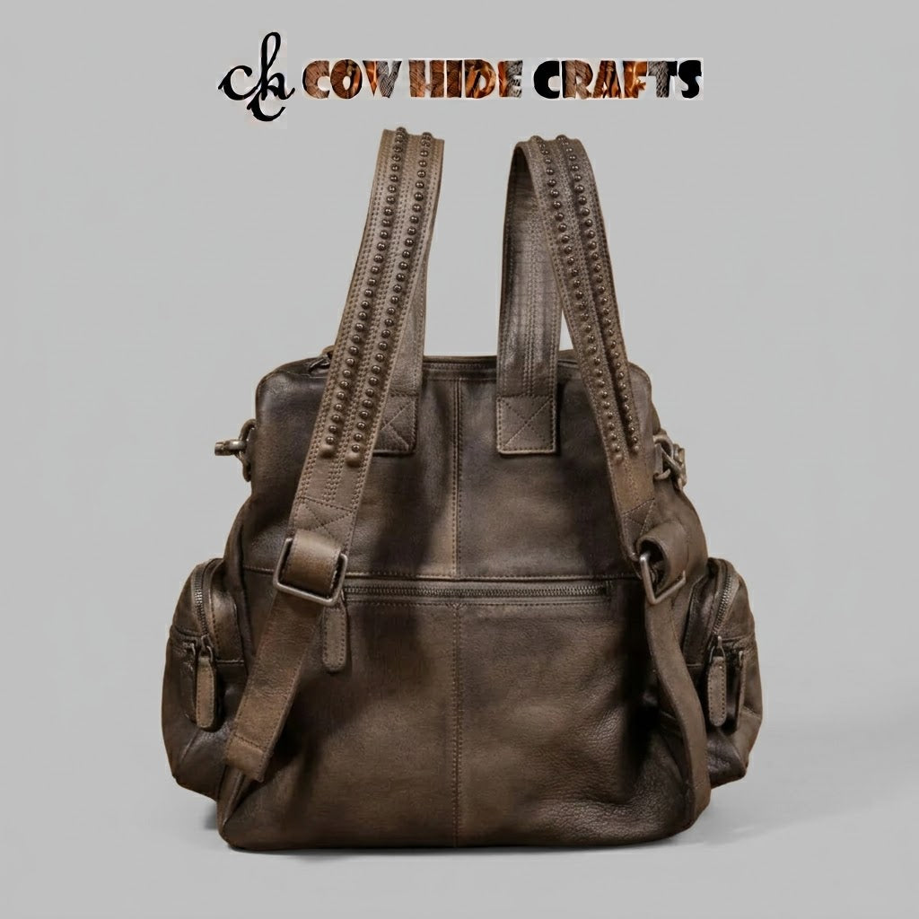 Shoulder strap stud row detail on slouchy leather backpack