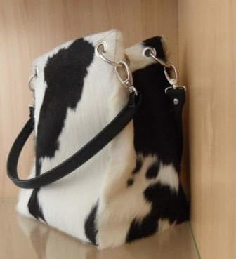 All-side genuine cowhide square bucket bag with silver eyelet leather straps and magnetic closure