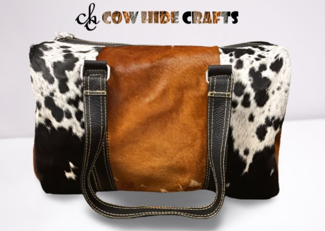 Brown center panel detail on tricolor cowhide duffle bag