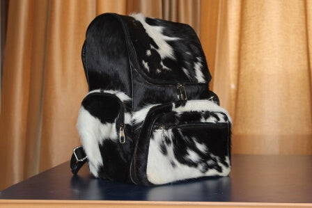 Genuine hair-on cowhide backpack with natural black and white fur