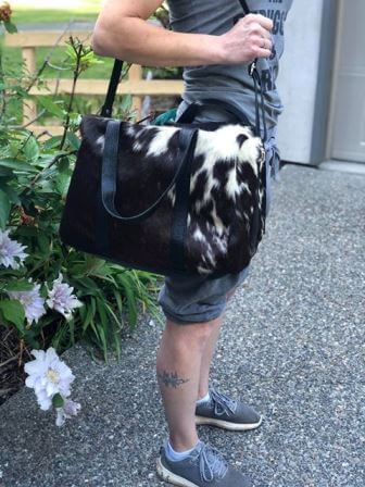 Handcrafted hair-on cowhide weekender duffle bag with natural markings