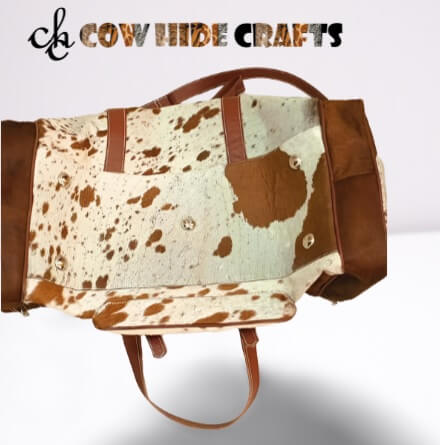 Tan and white duffle with metal feets on the base.