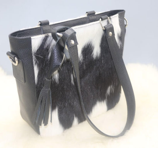 Black and white cowhide crossbody bag with leather strap