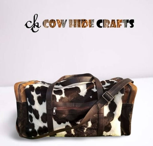 Brown and white cowhide duffle bag with leather trim