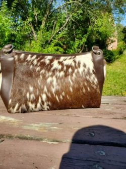 Brown cowhide handbag with zipper closure