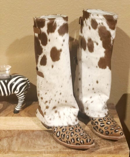 Western style cowhide boot cover over boots with buckle closure