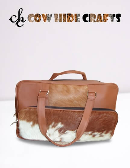 Tan and white cowhide front panel duffle bag