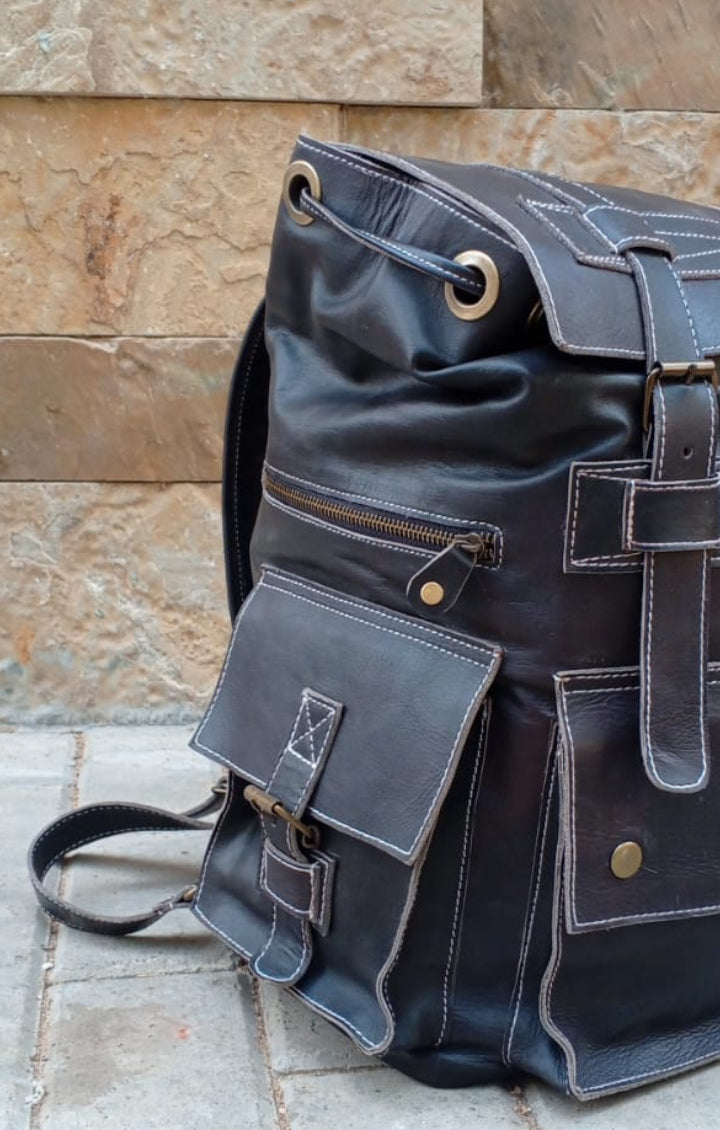 Full-grain rucksack lower snap pocket side flap utility pockets