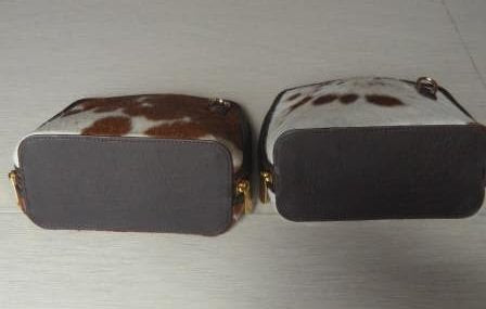 Tan and white cowhide crossbody bag zipper closure for casual dinner