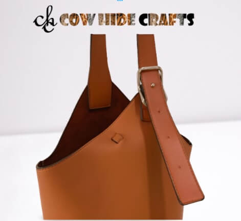 Adjustable leather shoulder strap on tan basket style bag