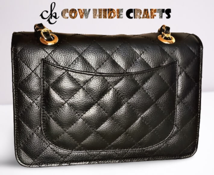 Back open pocket detail on black diamond quilted leather clutch