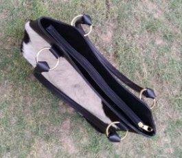 Black cowhide bag dual handles metal eyelets
