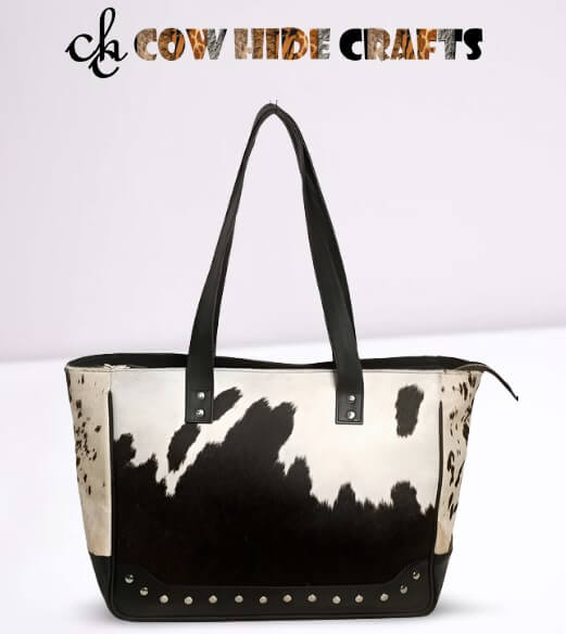 Black cowhide shoulder bag metal rivet detail