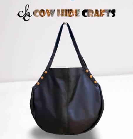 Black leather hobo bag with gold rivets front view women