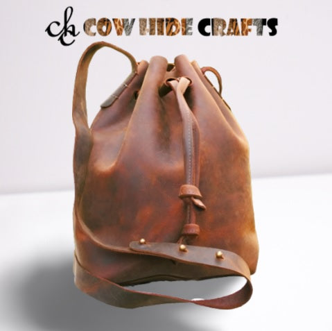 Brown distressed leather bucket bag drawstring closure 