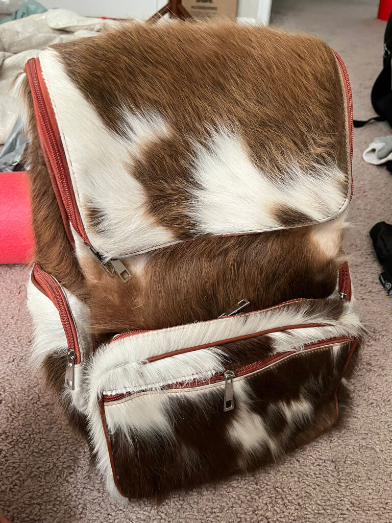 Brown hair on cowhide backpack tan white