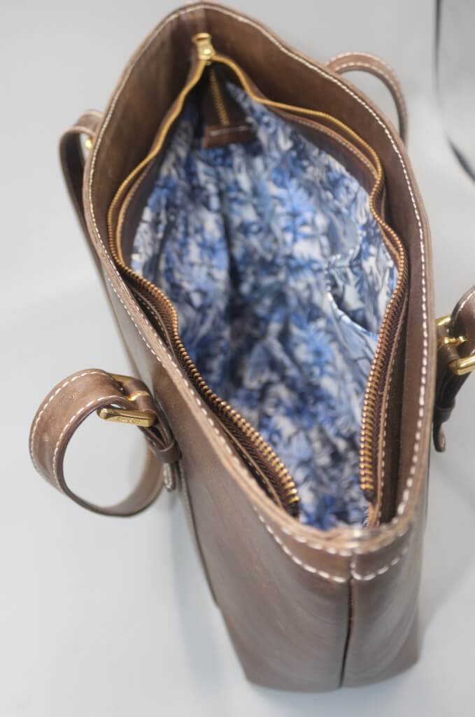 Brown leather tote gold zipper closure detail