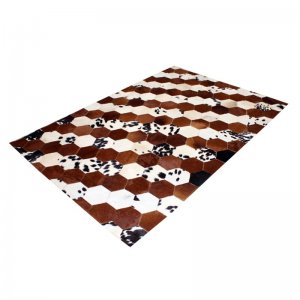 Brown white cowhide patchwork rug wavy pattern
