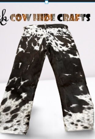 Button closure detail on black white hair-on cowhide pants