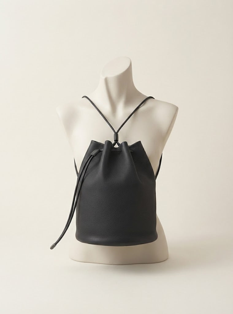 Drawstring closure detail on calfskin bucket backpack