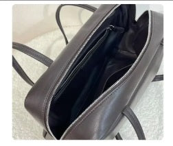 Full-length zipper closure detail on calfskin bowling bag