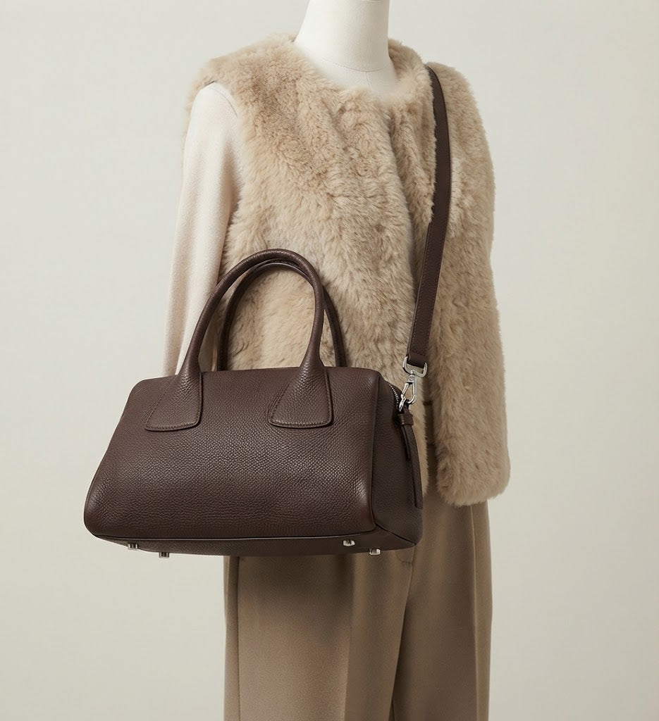 Detachable crossbody strap detail on calfskin Boston bag