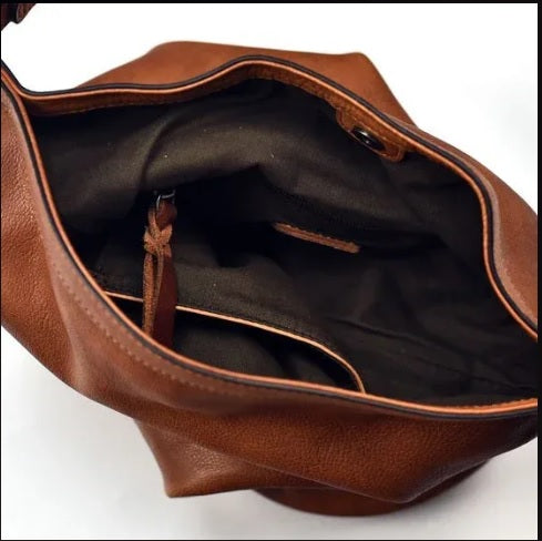 Fully lined interior with zip pocket inside cognac leather hobo bag