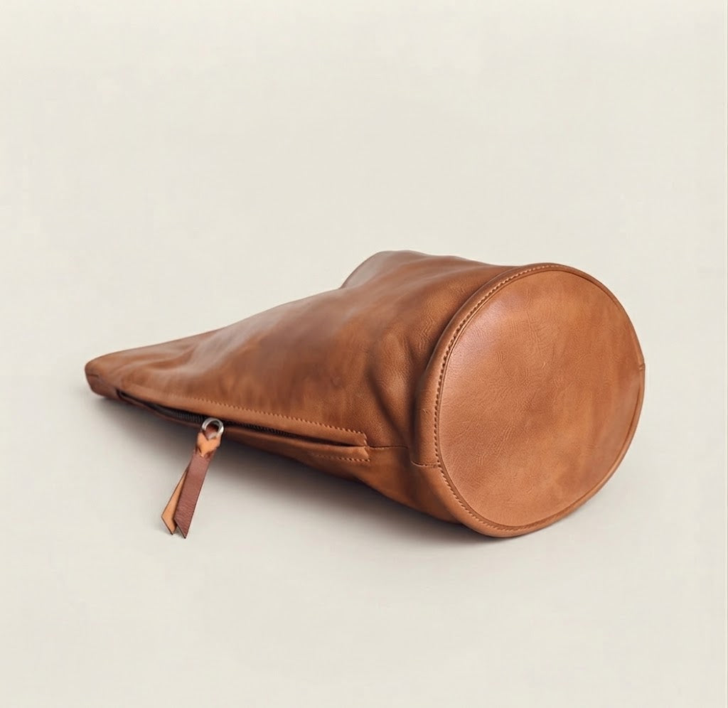 Side zip pocket with tassel pull detail on cognac hobo bag