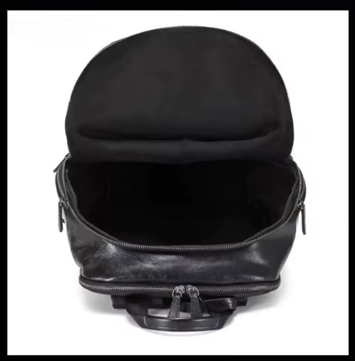 Mesh-lined shoulder strap detail on leather commuter backpack