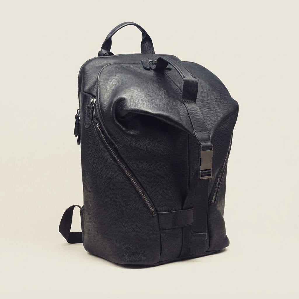 Roll-top compression strap and buckle detail on leather backpack
