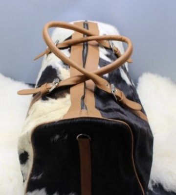 cowhide duffle bag with tan leather accents
