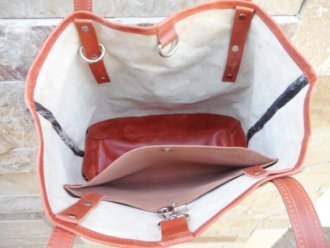 Unlined raw cowhide interior with leather pocket of salt pepper cowhide bucket shopper bag