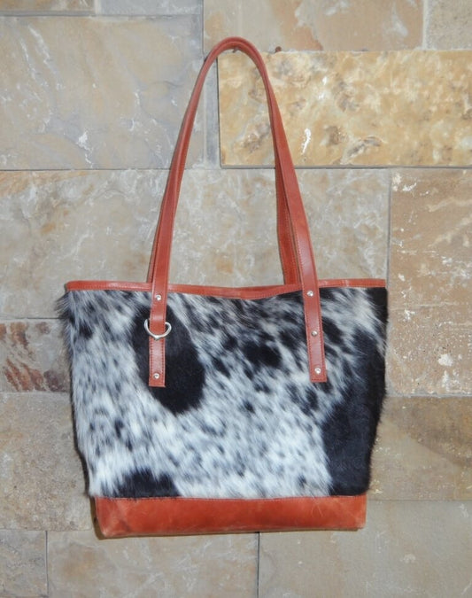 Salt and pepper black white cowhide bucket shopper bag with vintage tan leather – front view