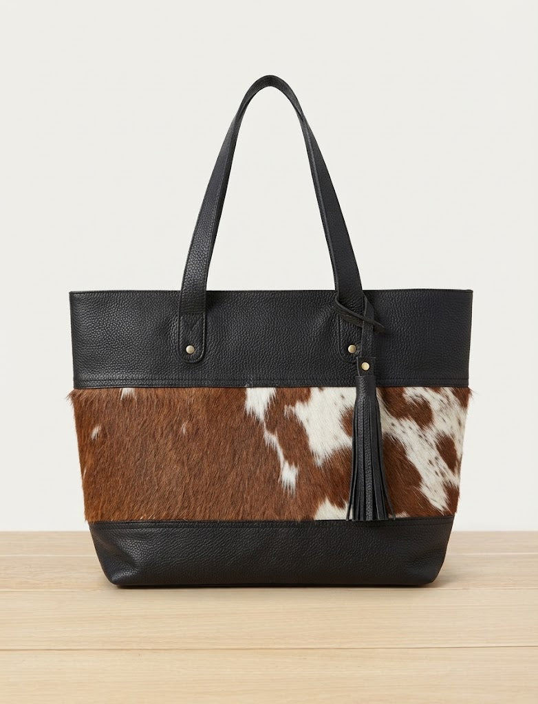 Pebbled leather top and bottom panel detail on cowhide tote