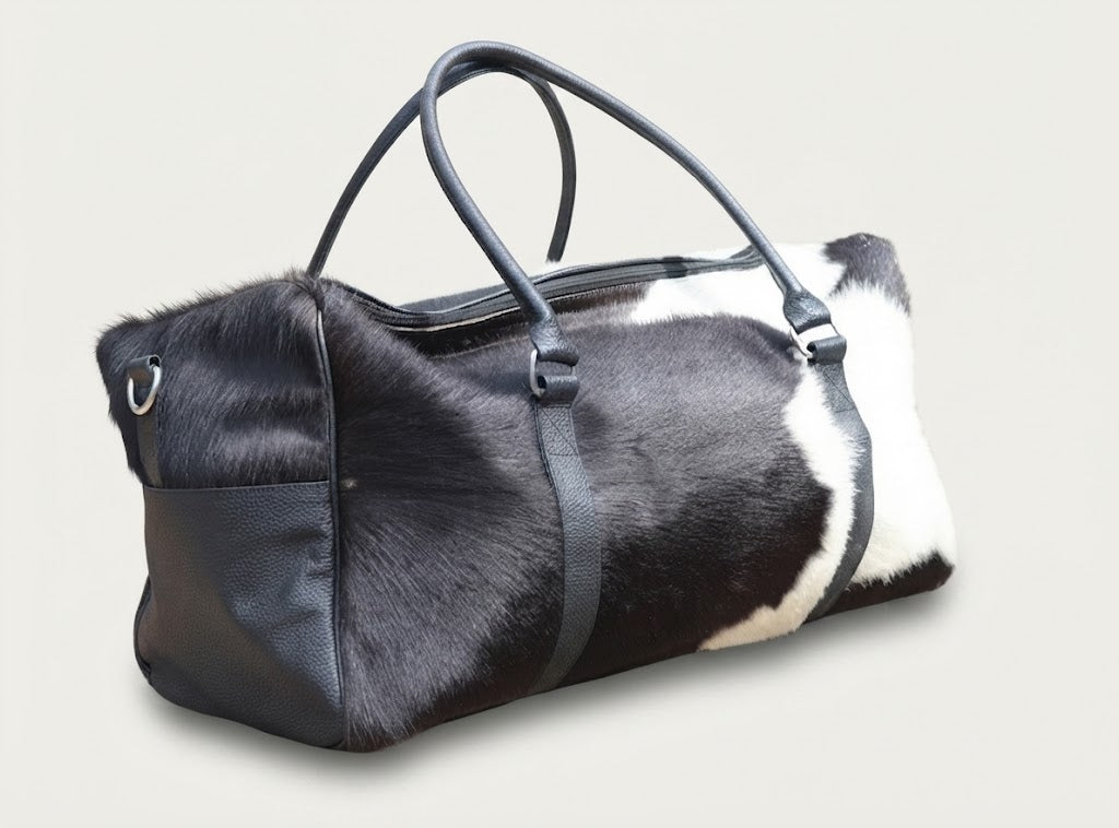 Dual-zipper closure detail on cowhide duffle bag