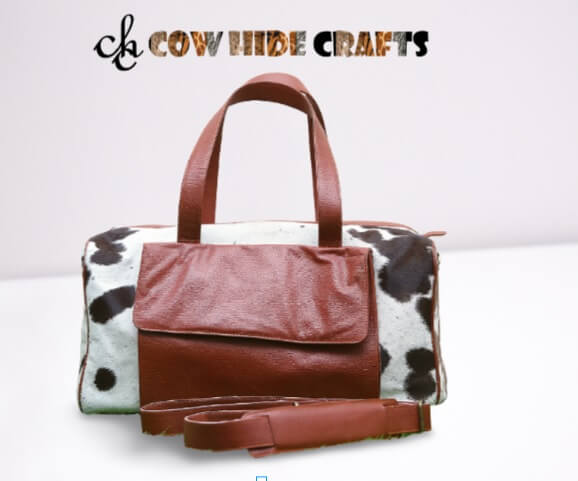 brown white cowhide duffle bag with flap pocket