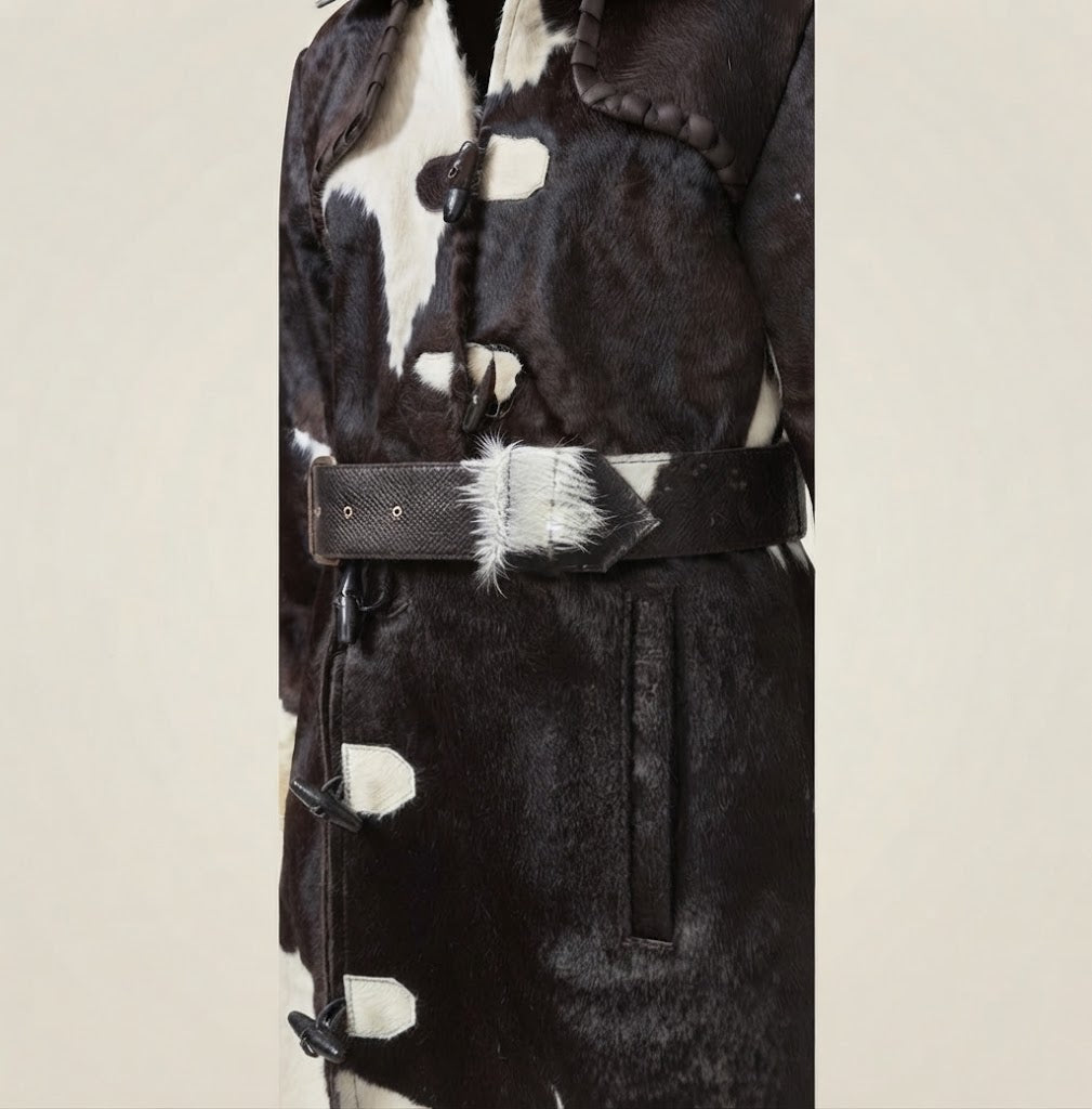 Vertical side pocket detail on black and white cowhide duster