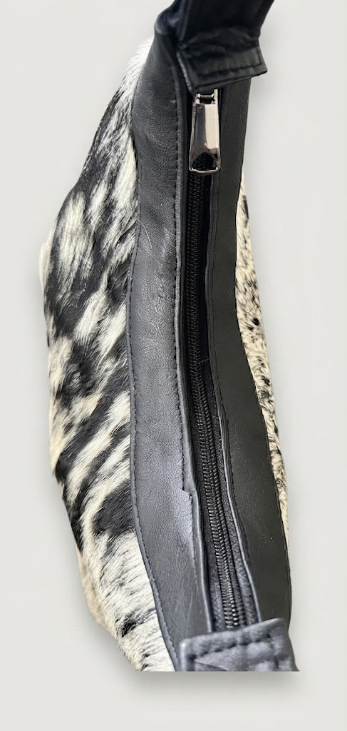 Top zipper closure detail on cowhide hobo bag