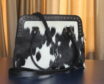 Cowhide leather bucket bag black and white with rivet detail