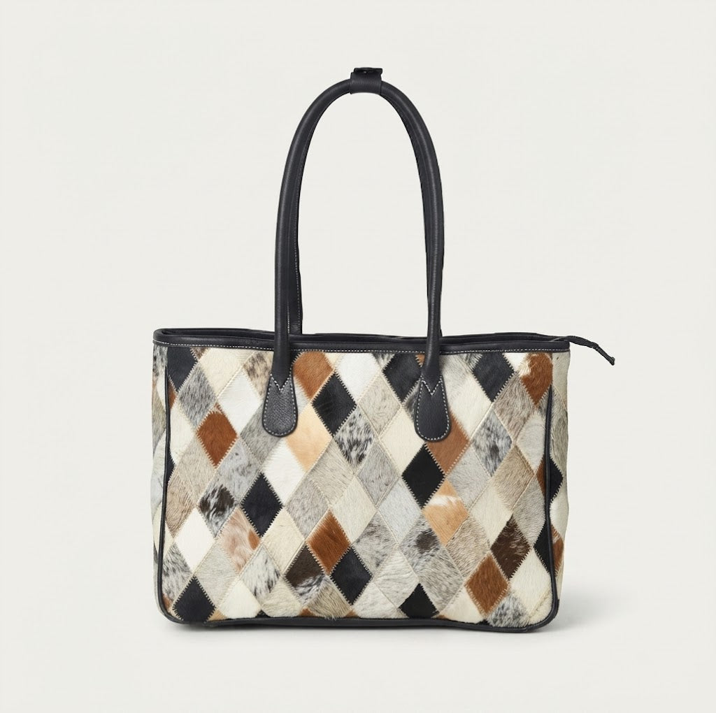 Geometric diamond panel detail on cowhide patchwork tote