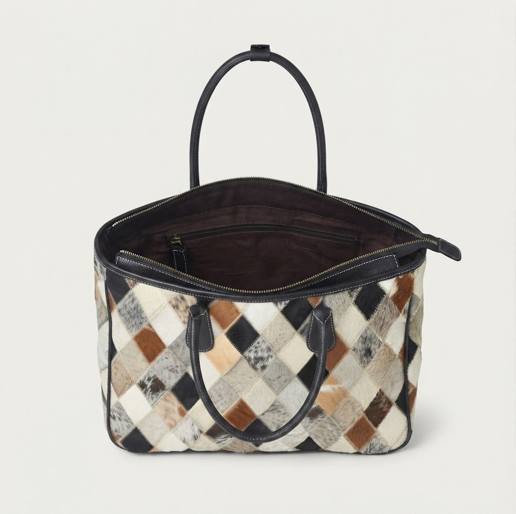 Fully lined interior with zippered pocket inside cowhide patchwork tote