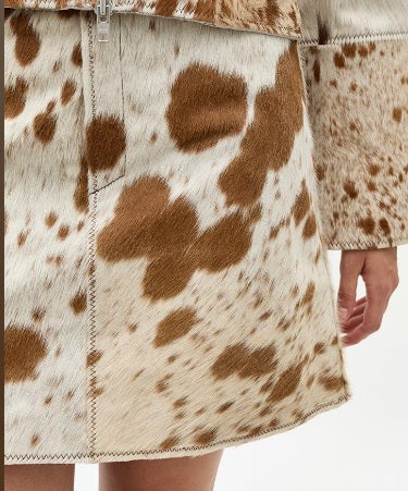 Raw-edge hem detail on knee-length cowhide shorts