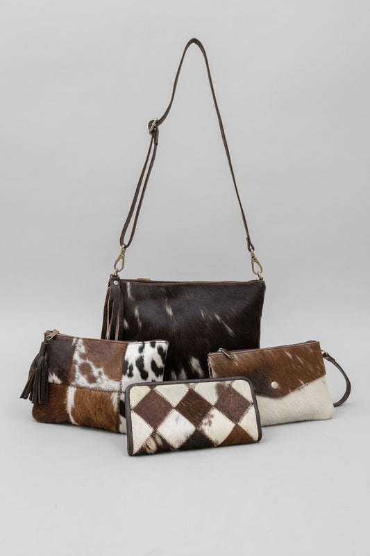 Western cowhide accessories collection with crossbody bag, patchwork wallet, cosmetic pouch and envelope wristlet.